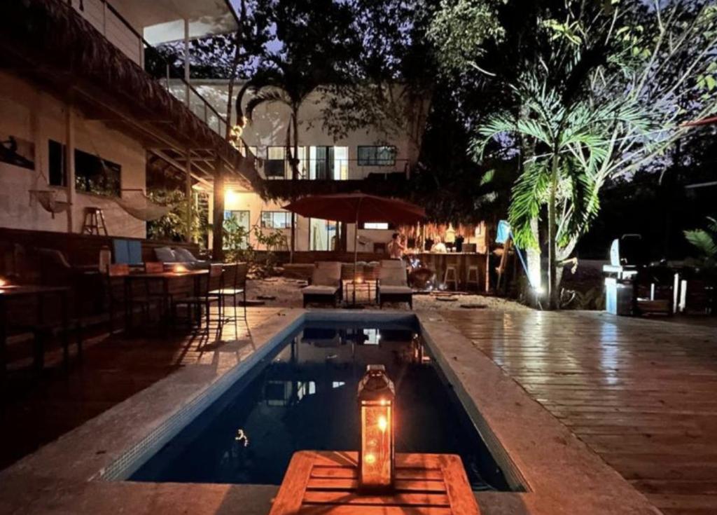 a swimming pool with a light in the middle of a building at La Sana Surf Hotel, Playa Carmen in Santa Teresa Beach