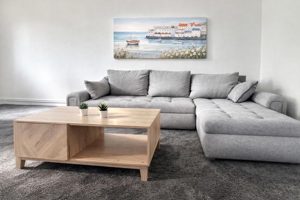 a living room with a couch and a coffee table at Cosy 2 Bedroom home by Cheshunt Station Free Wifi and Parking in Cheshunt