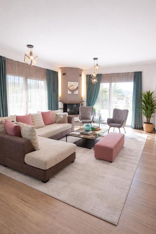 a living room with a couch and a table at Villa Anemos in Nafplio
