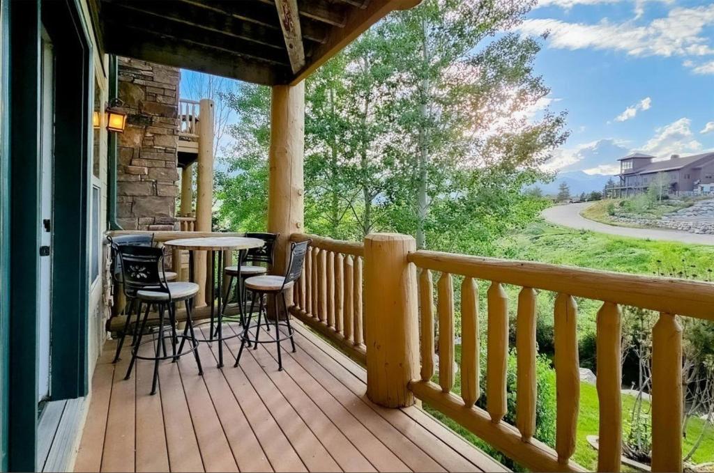 a porch with a table and chairs on it at Rustic Ridge MH304 Near Powder Mtn Hot Tub in Eden