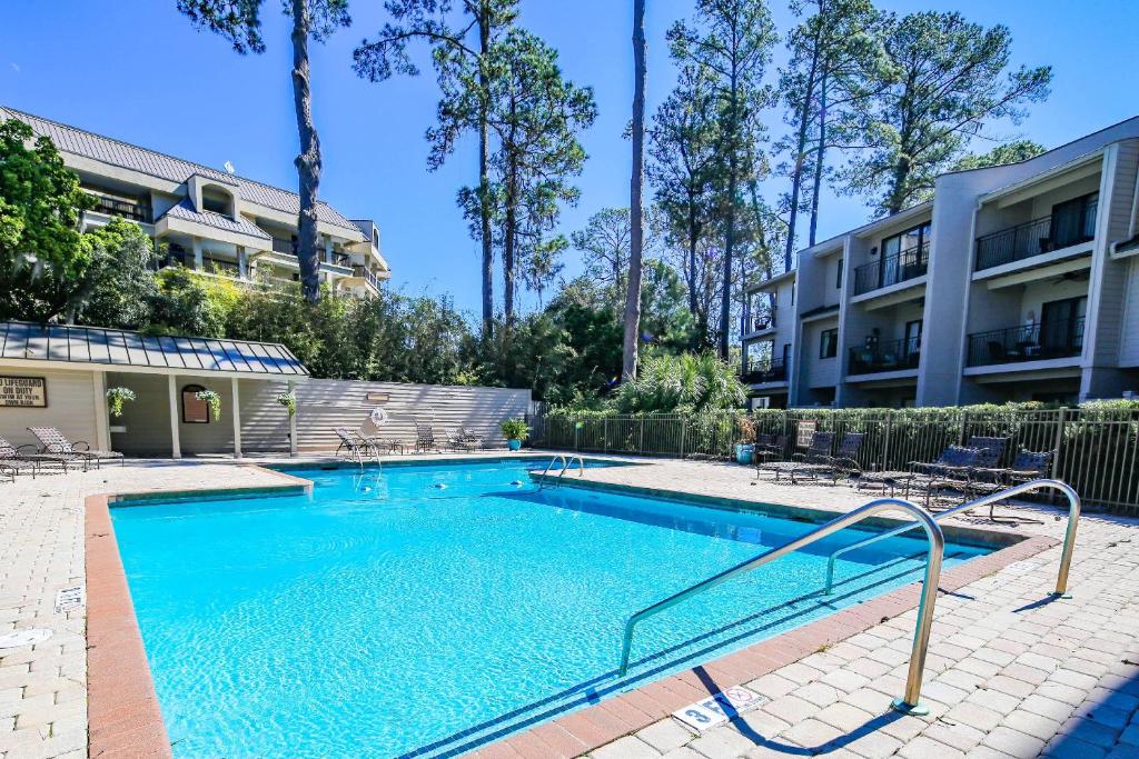 a swimming pool in front of a building at Harbour Town Haven in Hilton Head Island