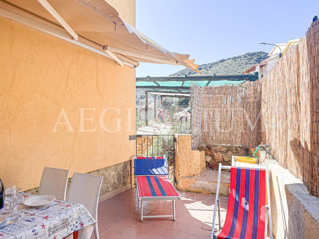 a patio with two chairs and a table with at Ginestra in Campese