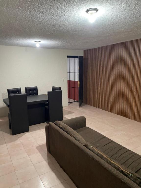an office with a couch and chairs in a room at Casa Fuentes in Zacatlán