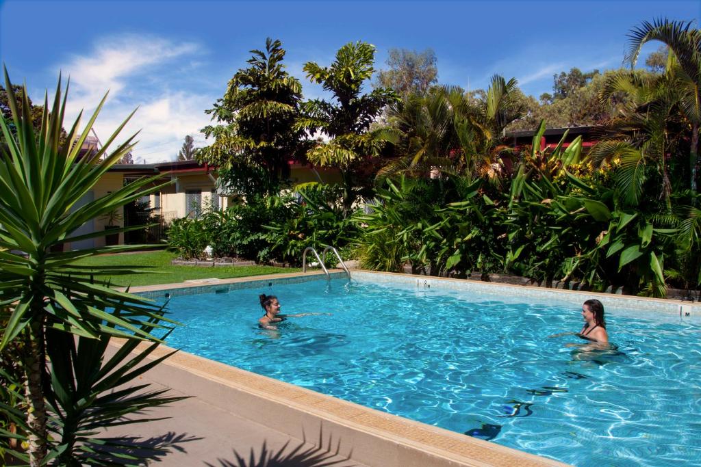 two women in the swimming pool at a resort at Jackaroo Motel in Mareeba