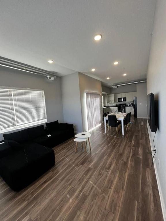 a living room with a black couch and a table at Graphite Loft in Des Moines