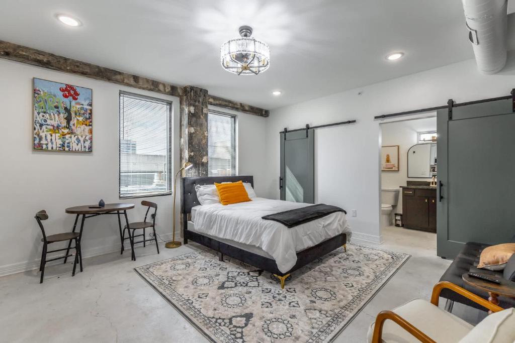 a bedroom with a bed and a table and chairs at Park Hotel Studio Suite 407 in Chattanooga