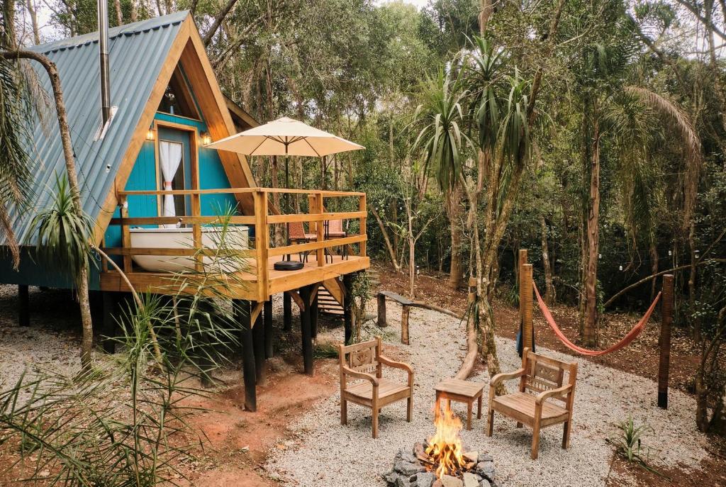 a tiny house with a fire in front of it at Cabana Rota do Vinho in São Roque