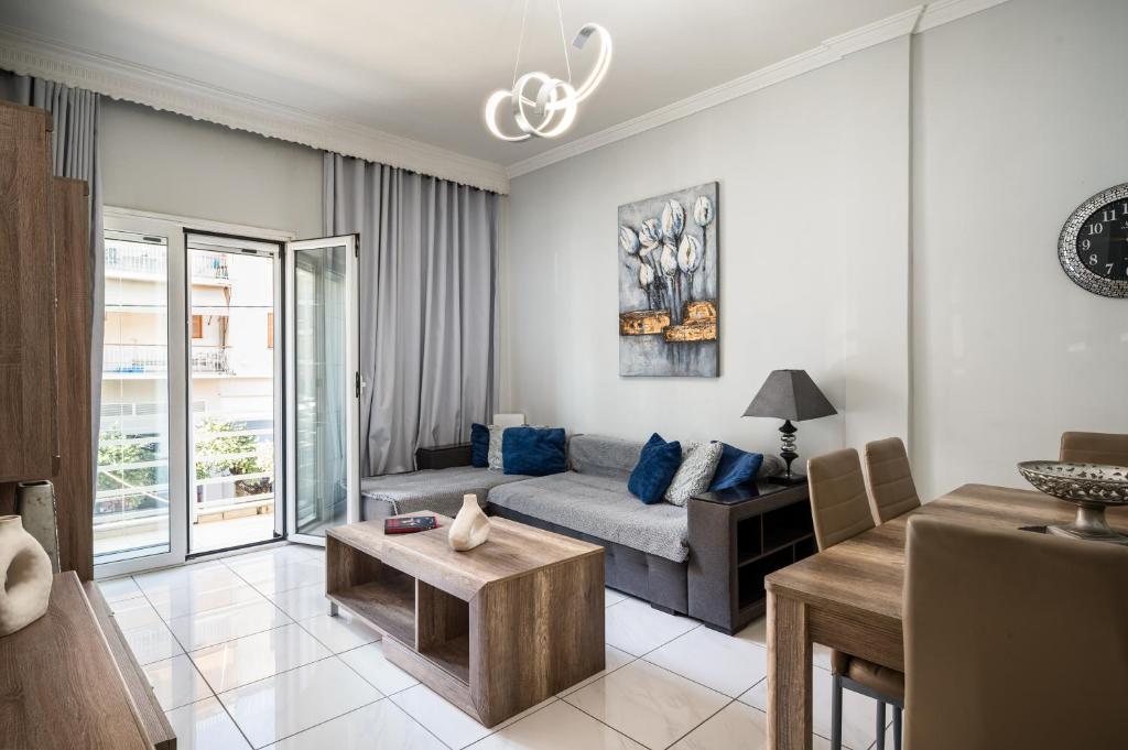 a living room with a couch and a table at Corfu City Center Design Residence incl private parking in Corfu