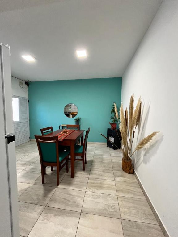 a dining room with a table and a blue wall at Cabana Alojamiento Turistico in Humahuaca