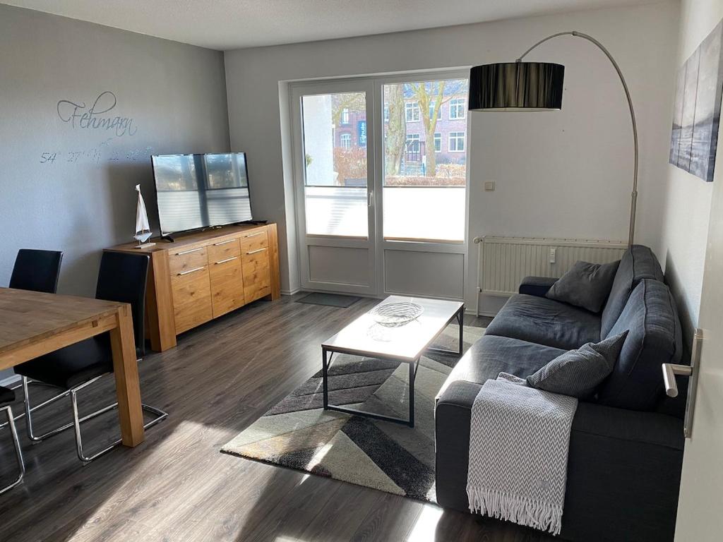 a living room with a couch and a table at Ferienwohnung Sonnenplatz in Fehmarn