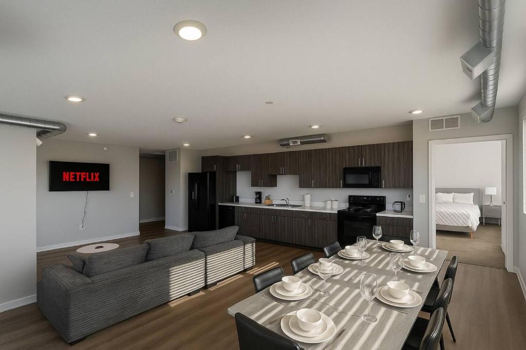 a living room with a dining table and a kitchen at Axis Suite in Des Moines