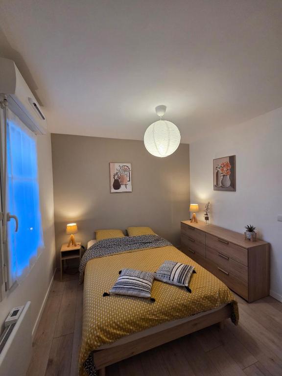 a bedroom with two beds and a large window at Eden lodge Chessy - 10min Disneyland - Parking in Chessy