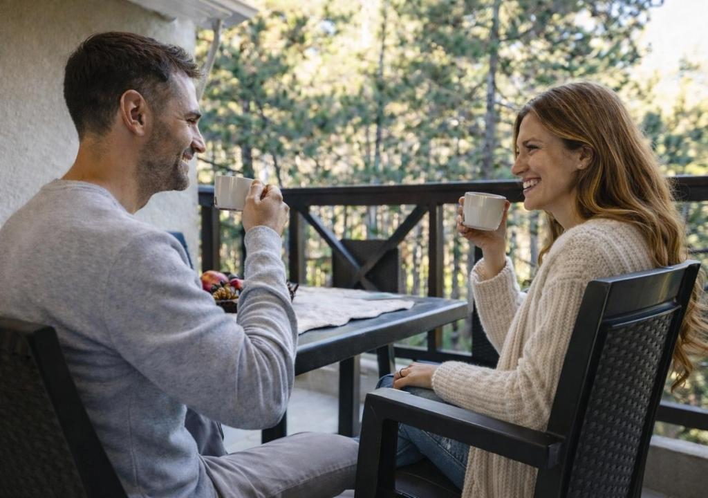a man and woman sitting at a table drinking coffee at Апартамент Боров рай in Velingrad