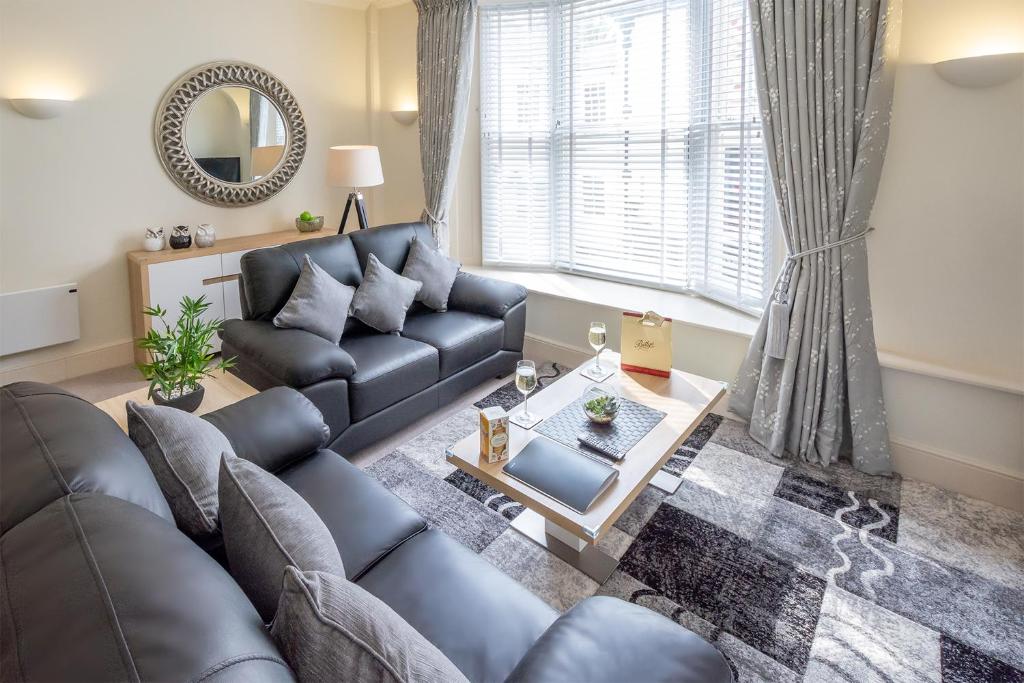 a living room with a couch and a table at Hunter House Holiday Apartment - York in York