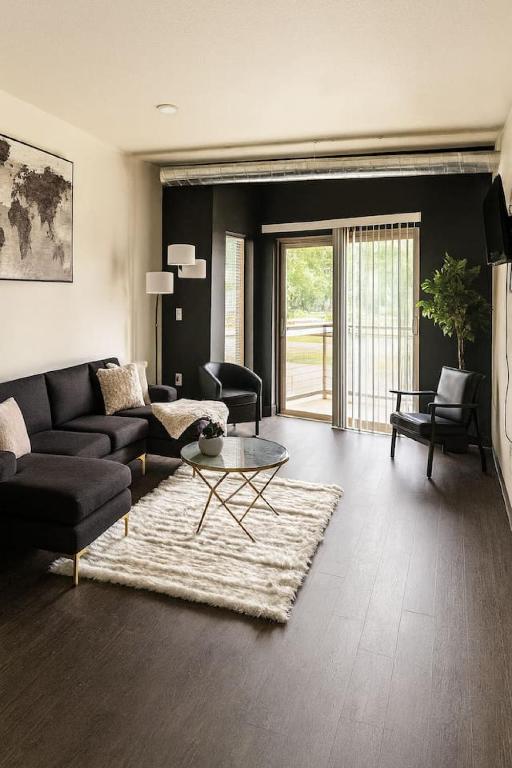 a living room with a couch and a table at Blackbeam Suite in Des Moines