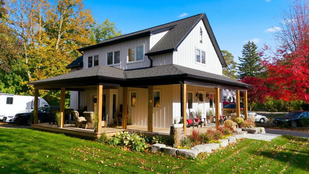 a house with a wrap around porch at Redwood Suite - NOTL Prime Location GETAWAY in Niagara-on-the-Lake