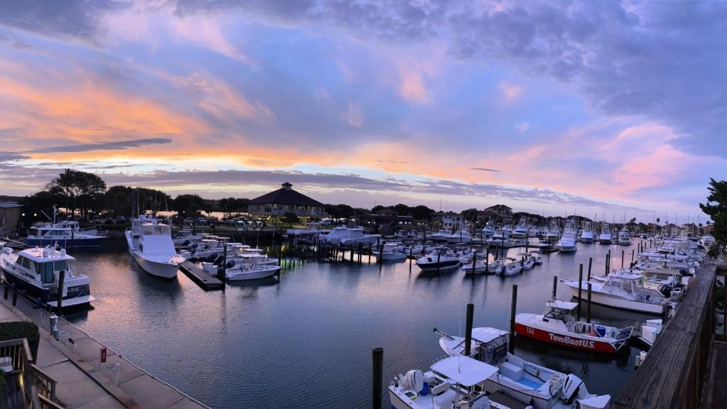 a group of boats docked in a marina at sunset at Inn at Camachee Harbor by CoolVacay in St. Augustine