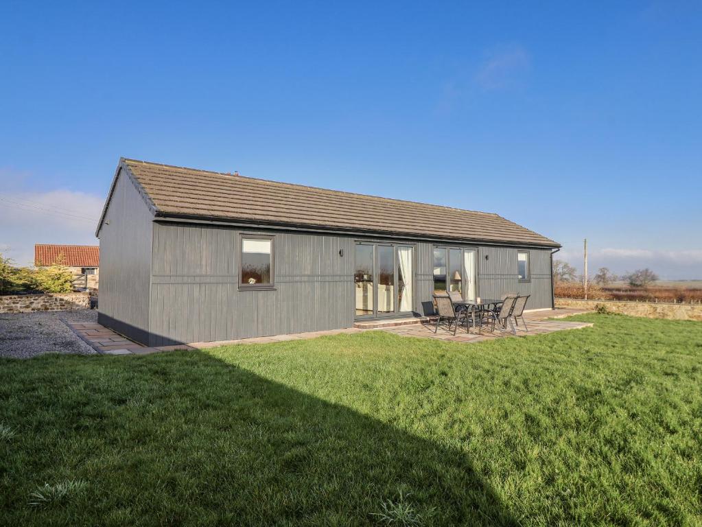 a small gray house with a grass yard at Fleetwood in Richmond