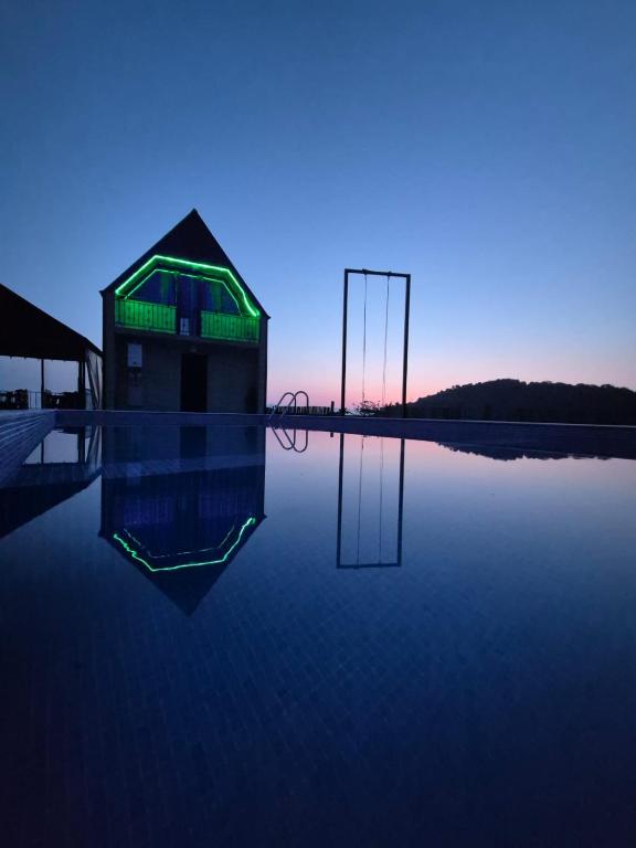 a building sitting on top of a body of water at Close to the sky in Agara