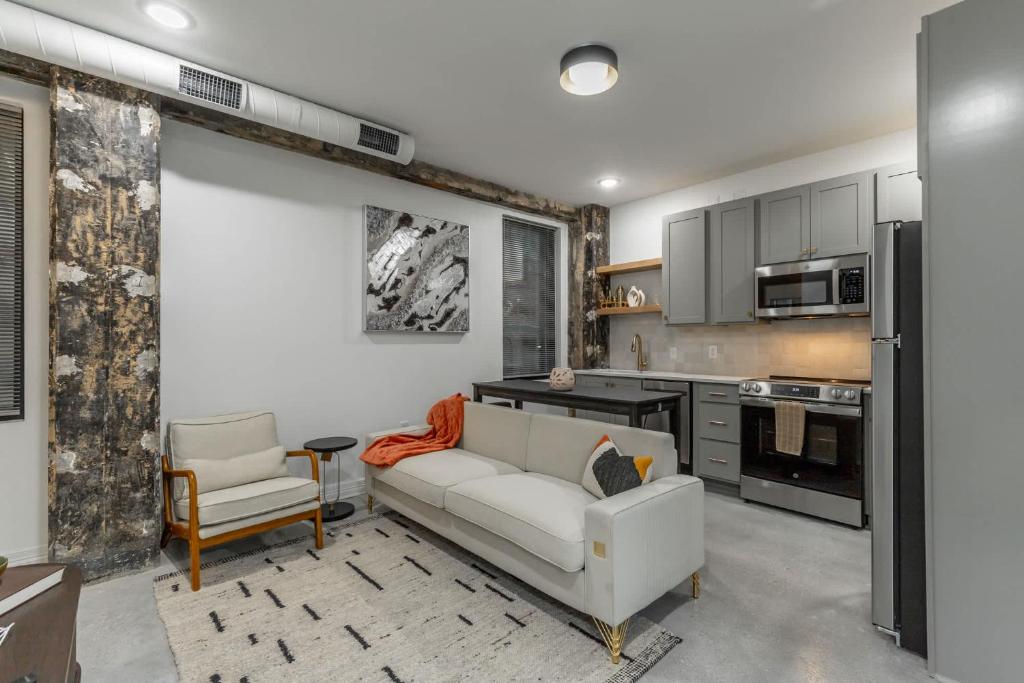 a living room with a couch and a kitchen at Park Hotel 1BR Suite 410 in Chattanooga
