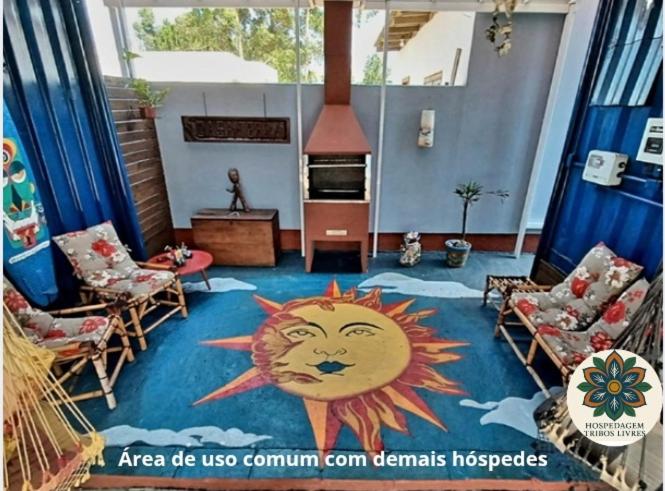 a living room with a sun painted on the floor at Hospedagem Tribos Livres in Torres