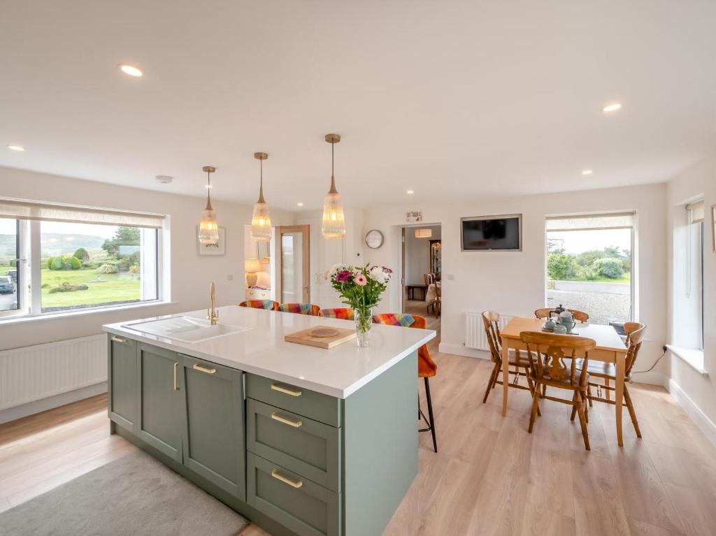 a kitchen and living room with a table and chairs at 3 Bed in Cashel oc-a32863 in Glinsk