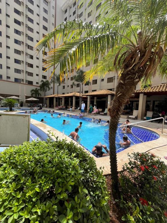 a group of people in a swimming pool at a hotel at Privê Boulevard Suíte Hotel - 706 - Caldas Novas GO in Caldas Novas