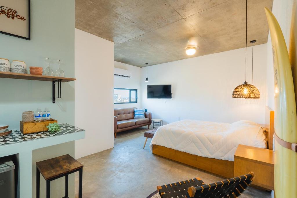 a bedroom with a bed and a living room at Ola in San Carlos