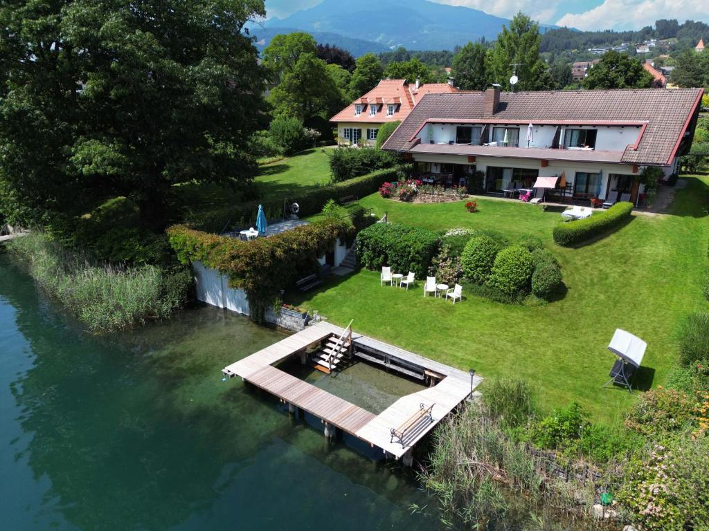 an aerial view of a house with a dock in the water at Haus Kapeller in Seeboden