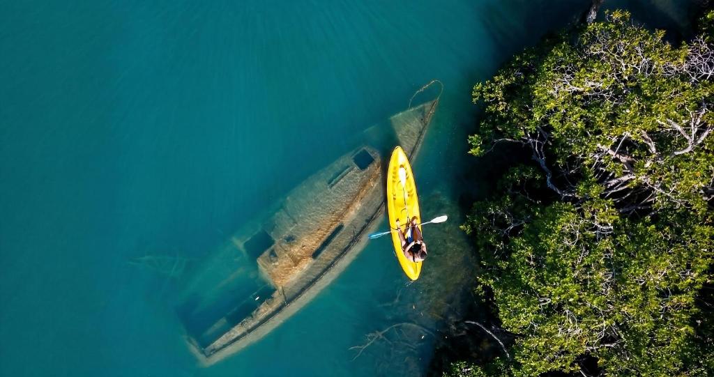 an aerial view of a yellow boat in the water at Tintipan Hotel in Tintipan Island