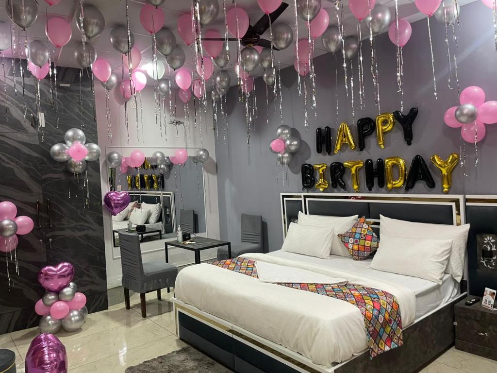 a bedroom with a bed with pink and black balloons at The City View- Hotel and Restaurant in Bhiwāni