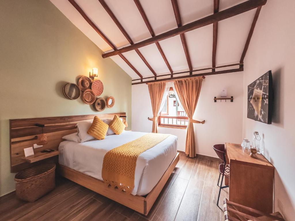 a bedroom with a large bed and a window at Casa Sie in Villa de Leyva