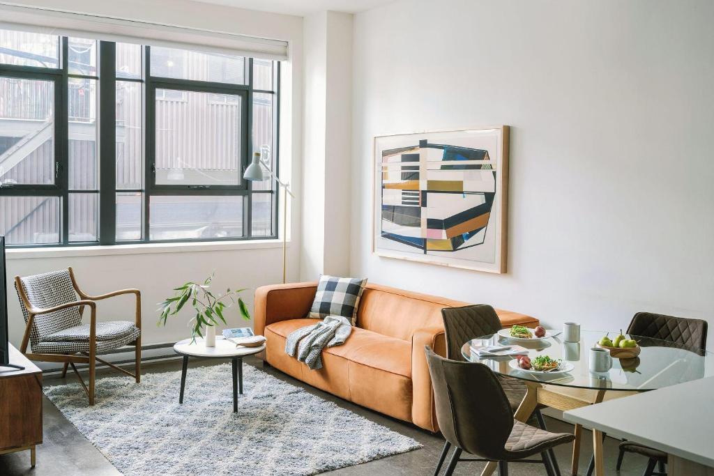 a living room with a couch and a table at The Cove Hotel - Plateau Mont-Royal in Montreal