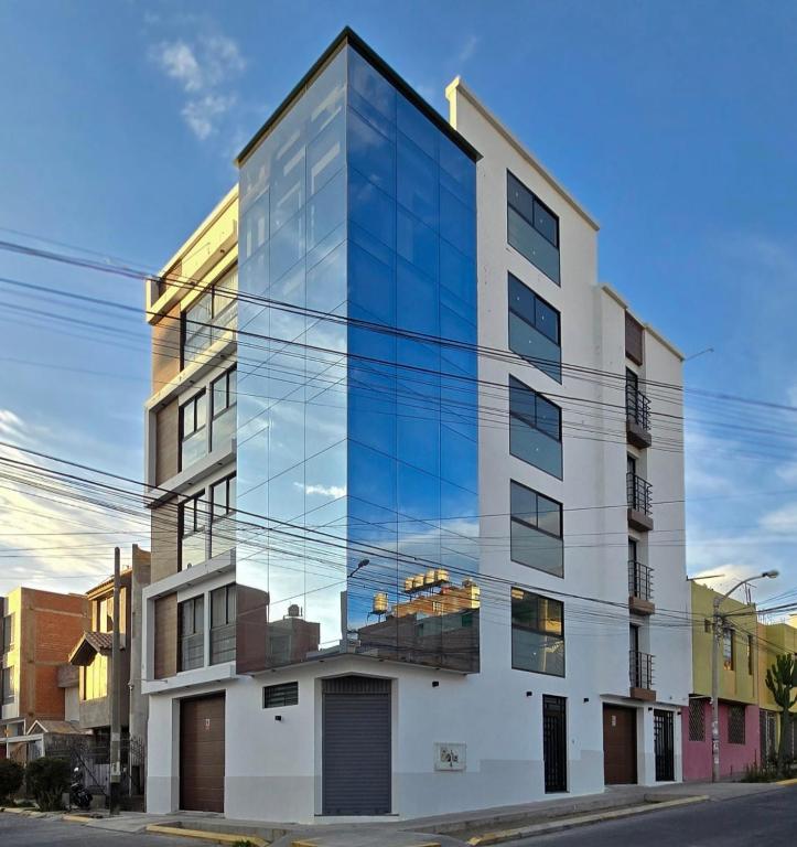 a tall building with glass windows on a street at HB Selection Hotel in Miraflores