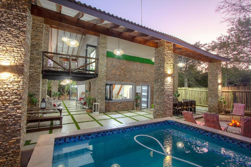 a house with a swimming pool in the backyard at Edjami River View in Marloth Park