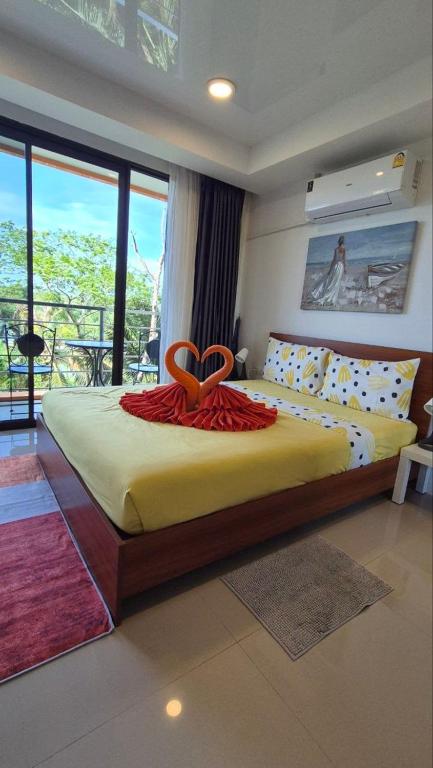 a bedroom with a large bed with a heart on it at PB325 Ideal studio apartment in Phuket in Ban Mai Salae