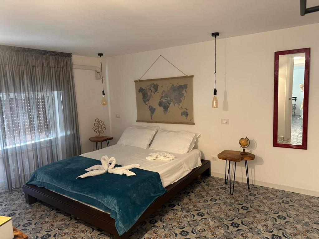 a bedroom with a bed with two towels on it at Duba Holiday House in Palermo