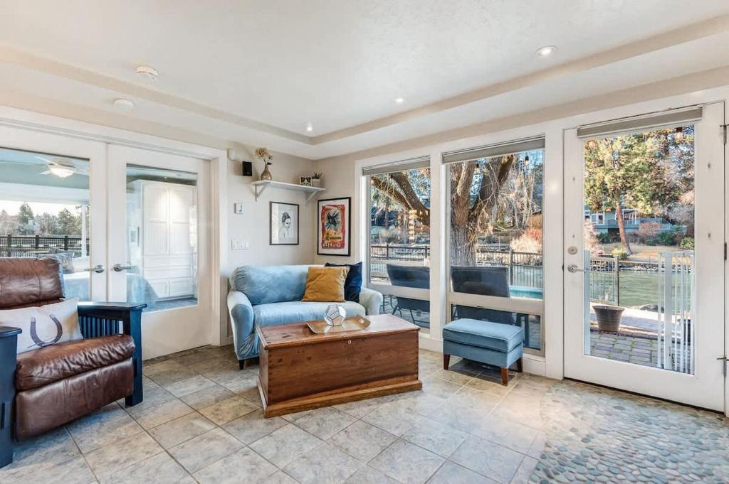 a living room with a couch and a table at Riverfront Cottage - Steam Room & Pet Friendly in Bend