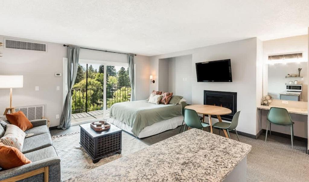 a bedroom with a bed and a living room at Riverview Pet Friendly Condo in Downtown Bend in Bend