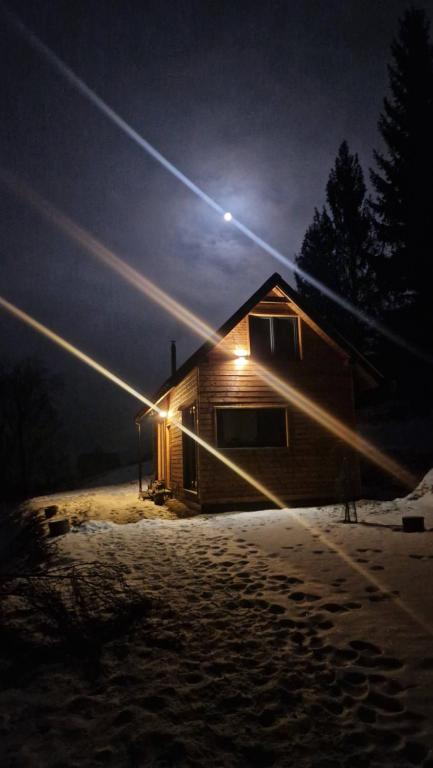a light on the side of a cabin at night at Chatka Bratka in Kletno