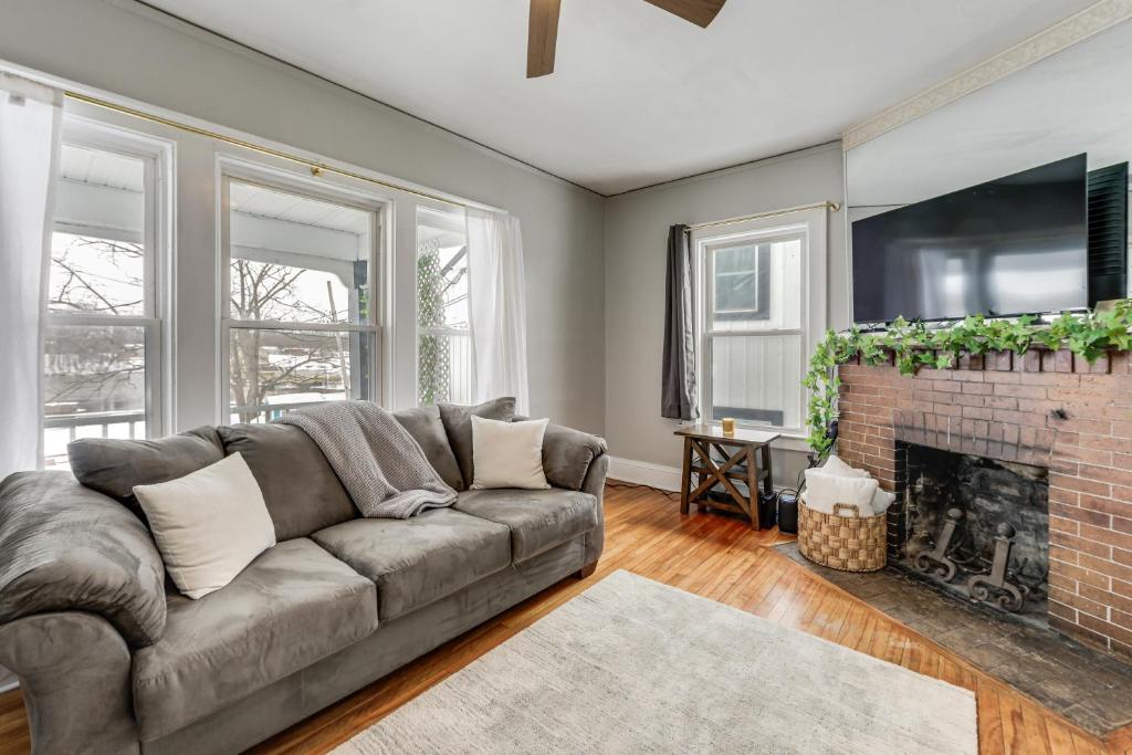 a living room with a couch and a fireplace at 8 Mi to Micron Technology! Walkable Phoenix Gem in Phoenix