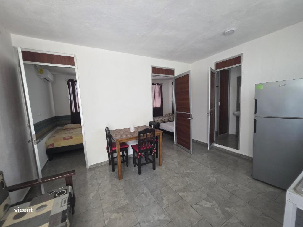 a kitchen and dining room with a table and a refrigerator at Nómadas in San Luis