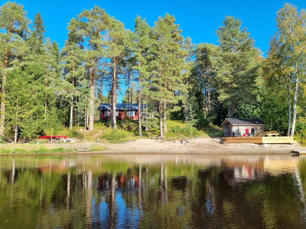 a cabin on the shore of a lake at The River House & Riverside Sauna in Kokkola