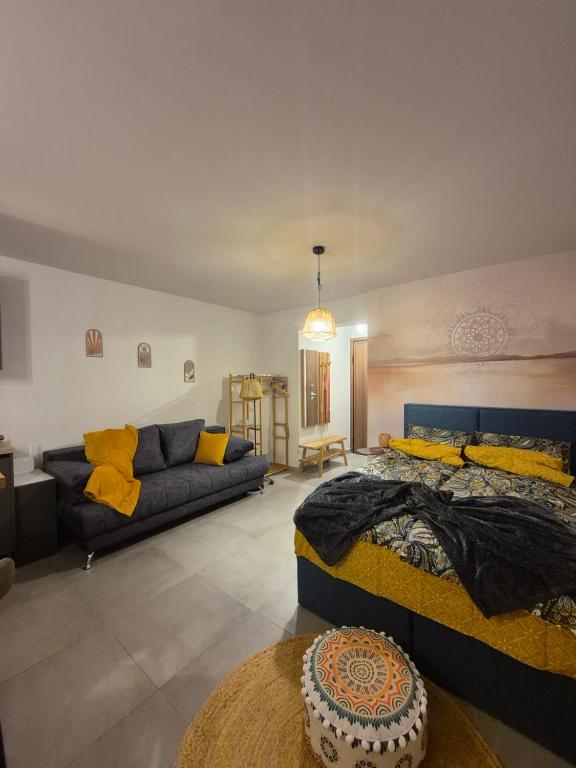 a living room with two beds and a couch at Boho Studio Enjoy in Neoi Epivates