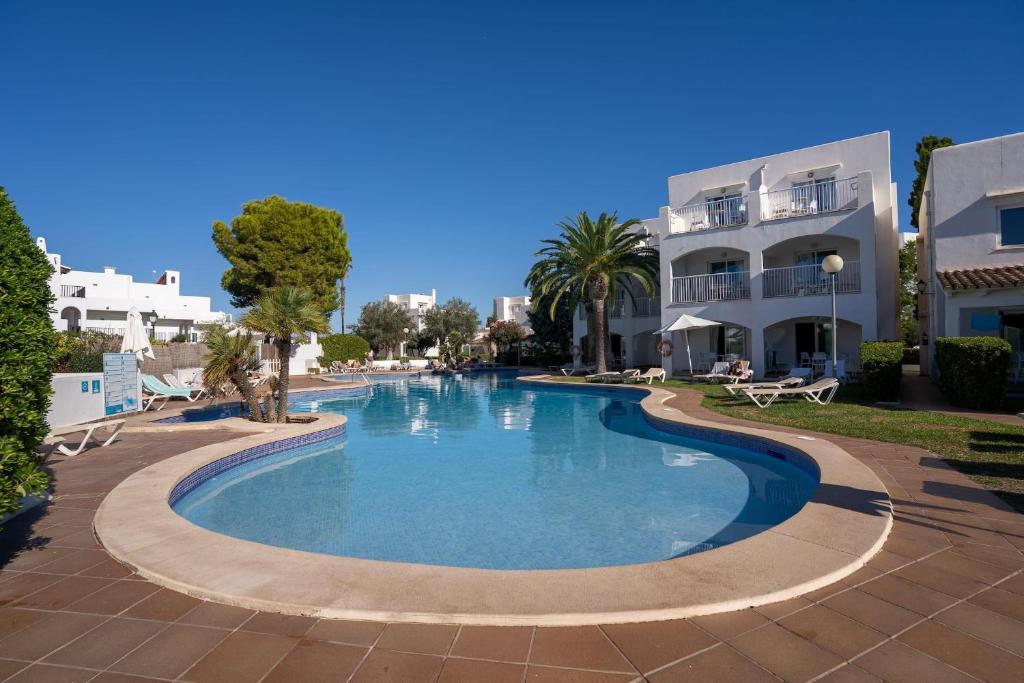 a swimming pool in front of a building at BLUESEA Ses Cases d'Or in Cala d´Or