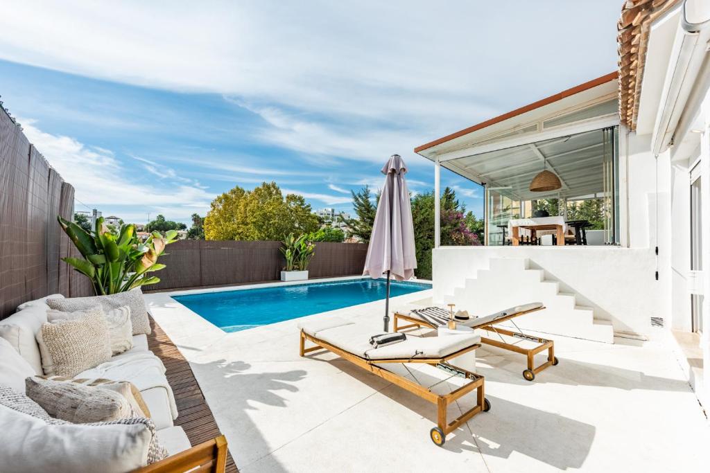 a patio with a swimming pool and a villa at Cozy Villa With Pool In Marbella Nueva Andalucia in Marbella