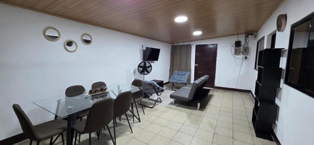 a room with a table and chairs in a room at Casa Petunia, Managua in Managua