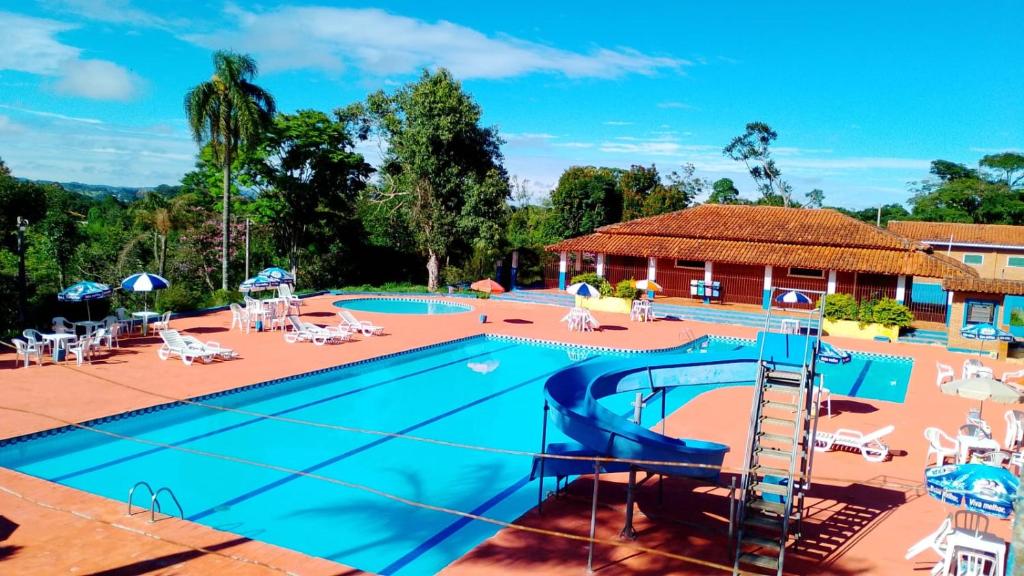 a pool at a resort with a slide at Spin world Clube São Roque in São Roque