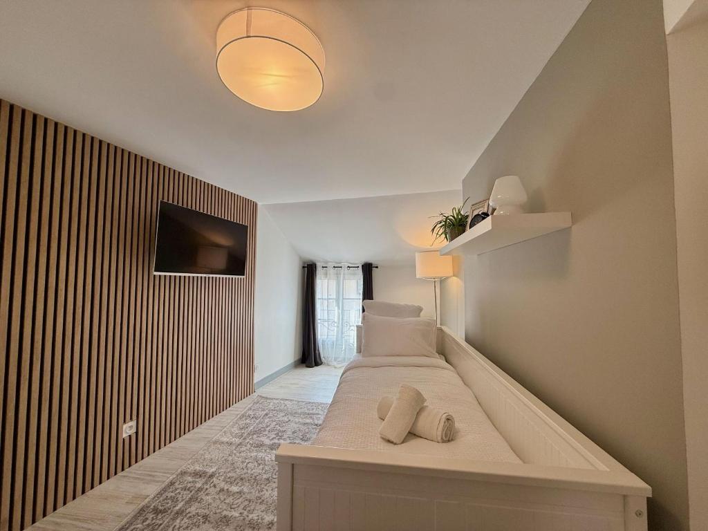 a bedroom with a bed with two pillows on it at Studio du Vieux Marché in Romorantin