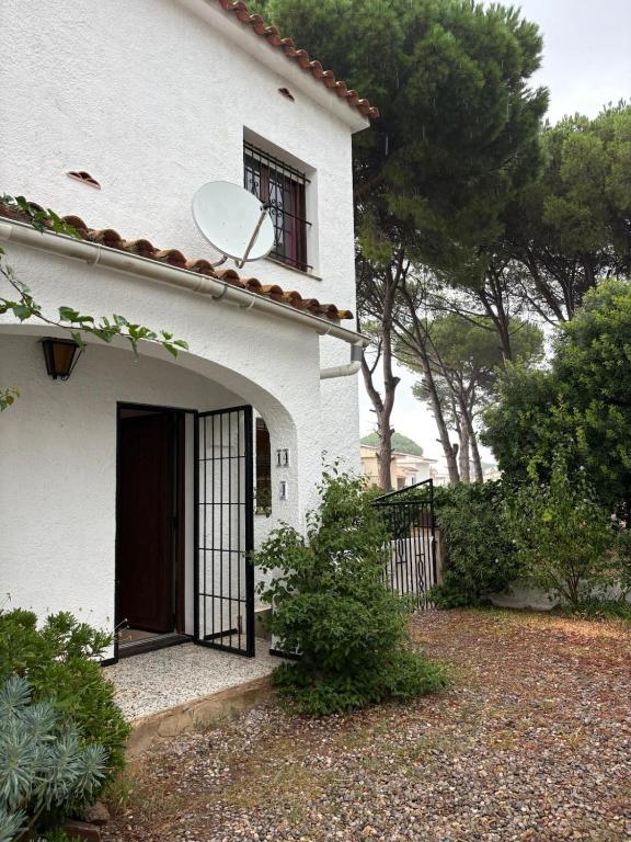 a white house with a door and a fence at Casa Calma in L'Escala